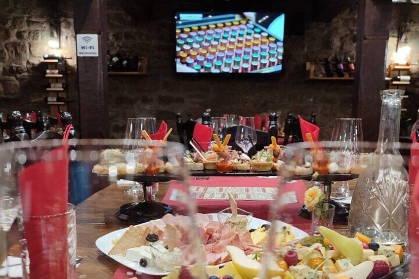 A restaurant with a variety of dishes on the table, a TV screen in the background, and a Wi-Fi sign. 5