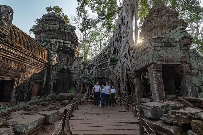 A temple with intricate carvings and a wooden bridge. 4