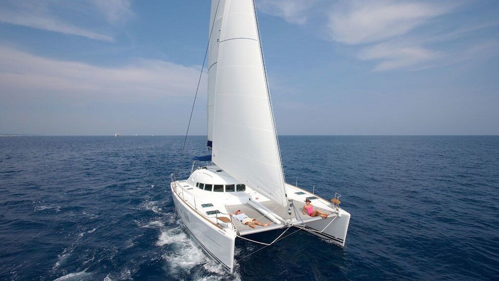 Relaxing view of a Catamaran on the waters of Santorini 