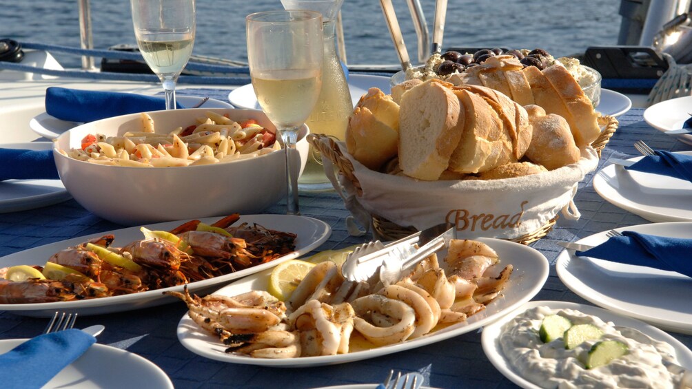 Plates of food on the table aboard a cruise boat on Santorini 