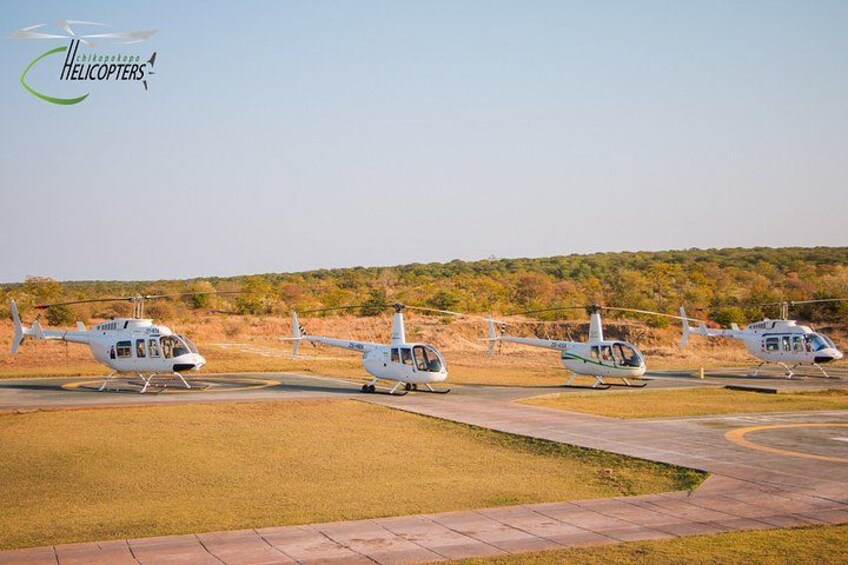 Un helipuerto con cuatro helicópteros estacionados. 1