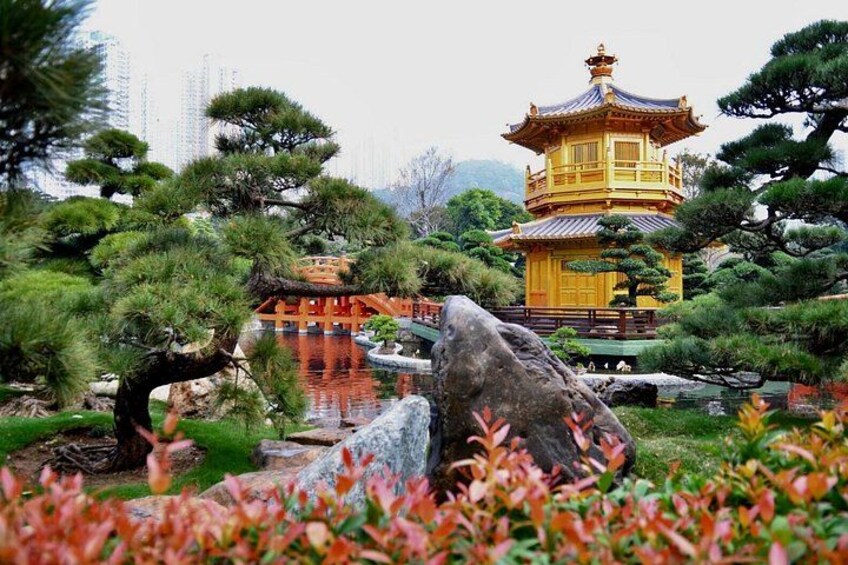 A traditional Japanese pagoda, a pond, and surrounding greenery. 4