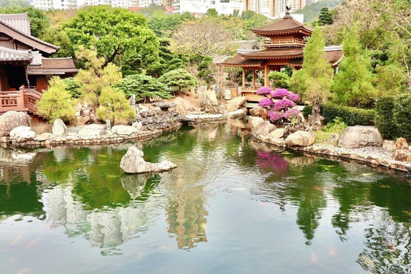 A traditional Japanese garden with a pond, rocks, and a pavilion. 3