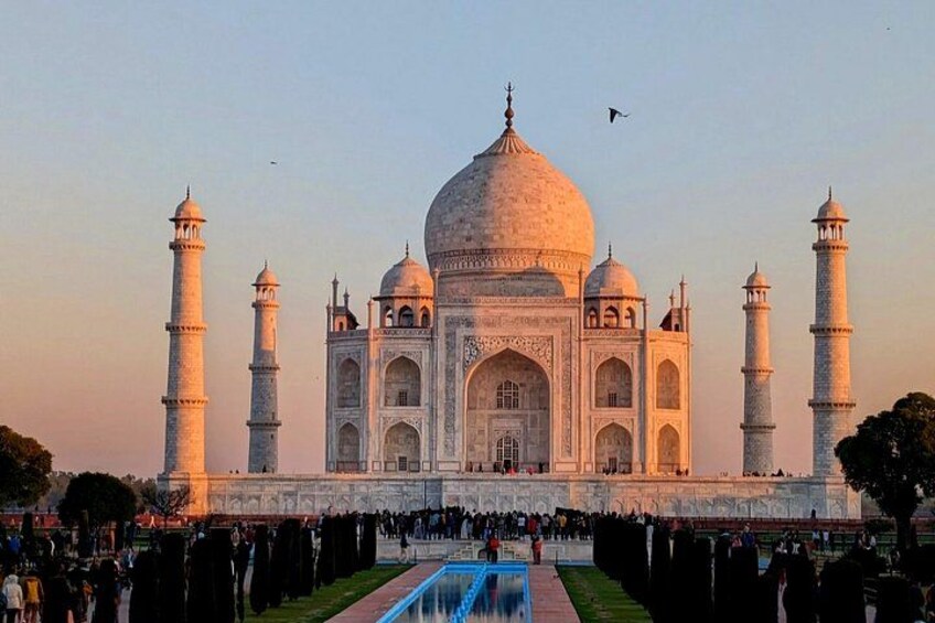 The Taj Mahal with four minarets, a large central dome, and a reflection pool in front. 3