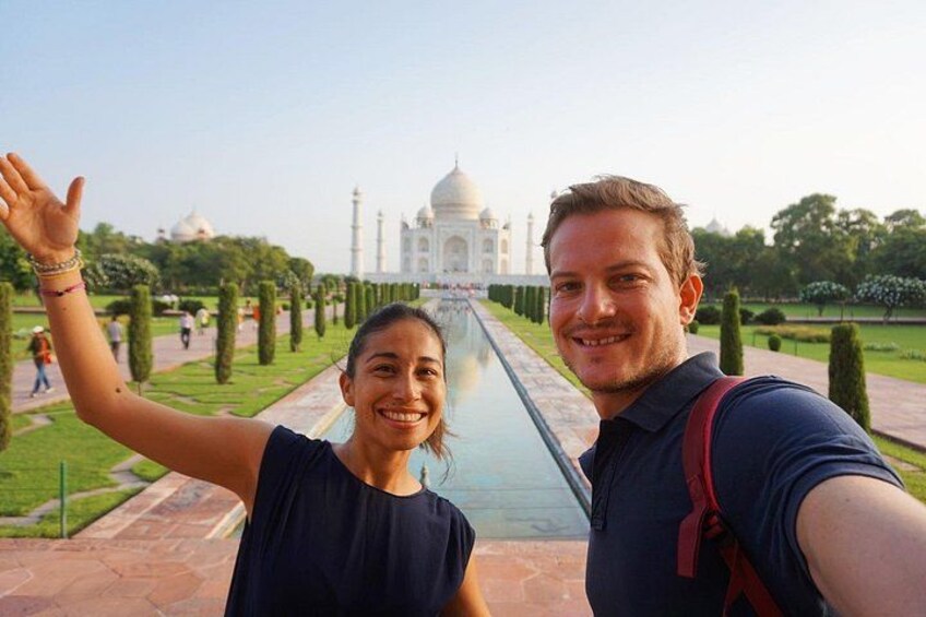 A person taking a selfie with the Taj Mahal in the background. 4