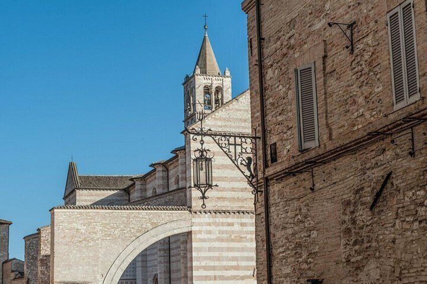 A historic stone building with a bell tower and arched entrance. 2