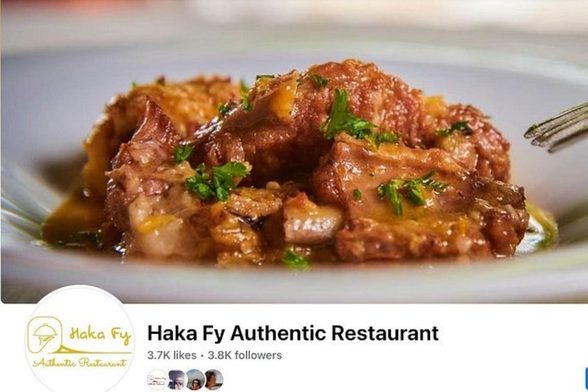 A dish of braised meat garnished with herbs. 1