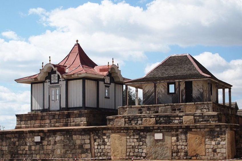 A historic building with a red roof and stone walls. 4