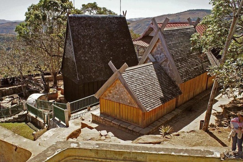 A traditional windmill with a steep roof, wooden structures, and a stone staircase. 2