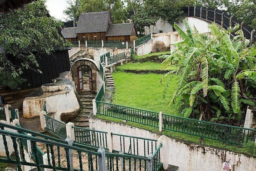A staircase leading to a building, surrounded by greenery and a small water feature. 3