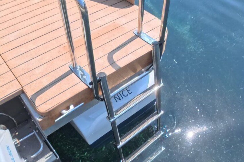 A wooden deck with metal railings and a sign that reads 'NICE.' 5