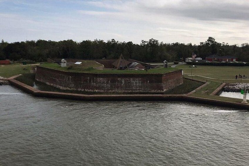 A fort with a grassy area and a flagpole. 2
