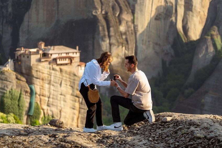 A couple on a rocky outcrop with a mountainous landscape in the background. 1