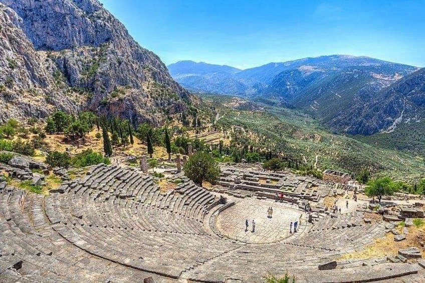 An ancient amphitheater surrounded by mountains. 4