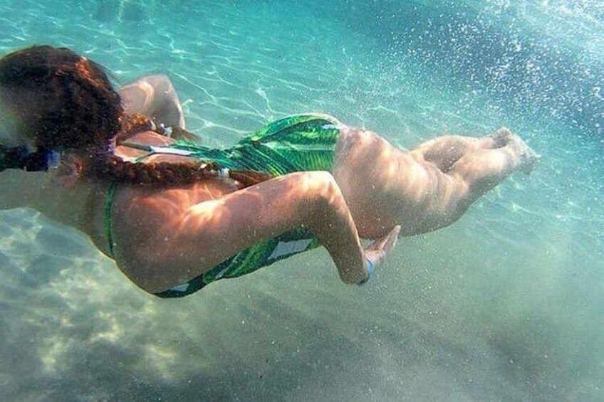 A person swimming underwater. 1