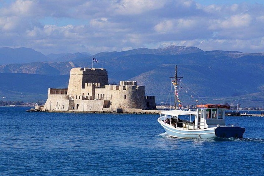 A coastal fortress, a small boat, and a mountainous landscape. 2
