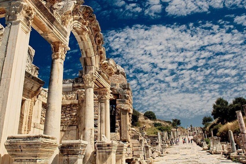 Ancient ruins with columns and arches under a clear sky. 2