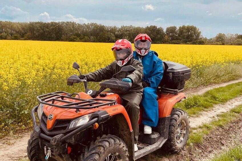 Dos personas en un cuatrimoto en un campo. 4