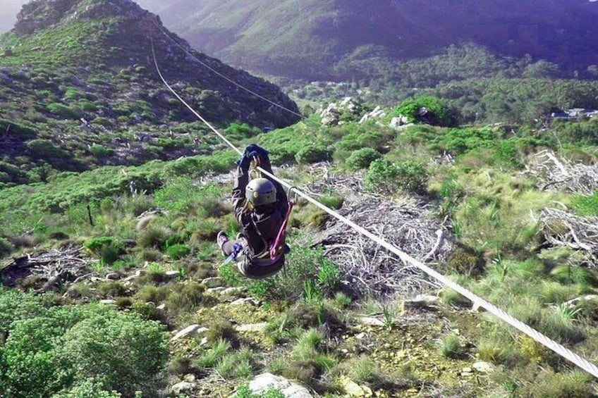 A person rappelling down a mountain with a rope. 3