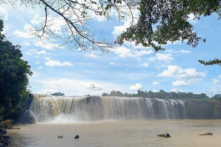 A waterfall, water, boats, and trees. 4