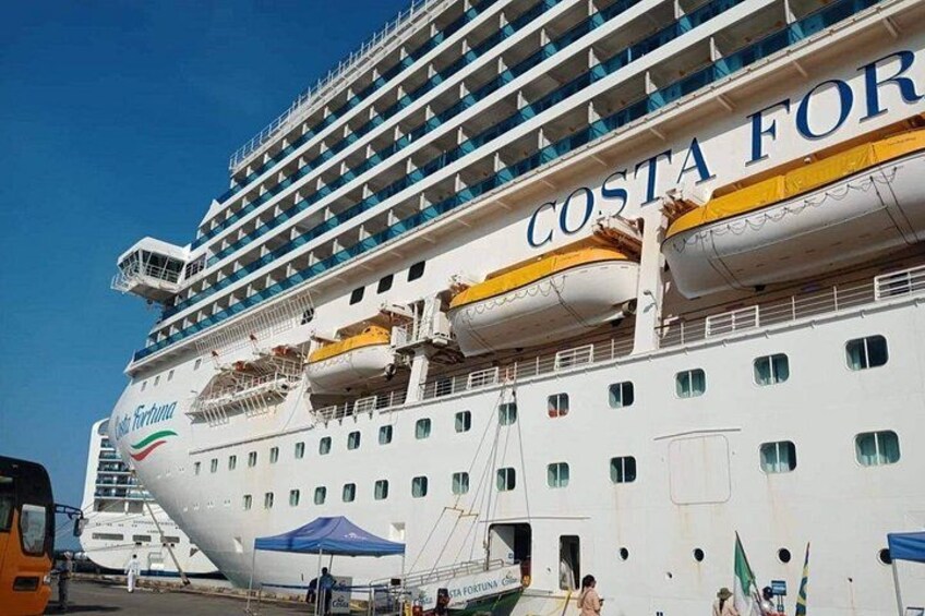 A large cruise ship named Costa Fortuna docked at a port. 5