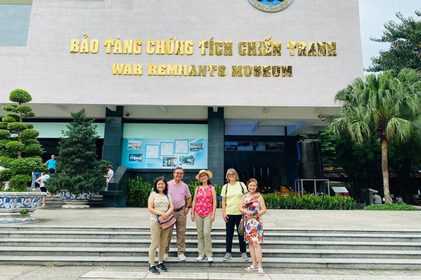 A group of people standing in front of the War Remnants Museum. 3