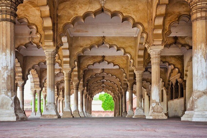 An architectural corridor with arches and columns. 4