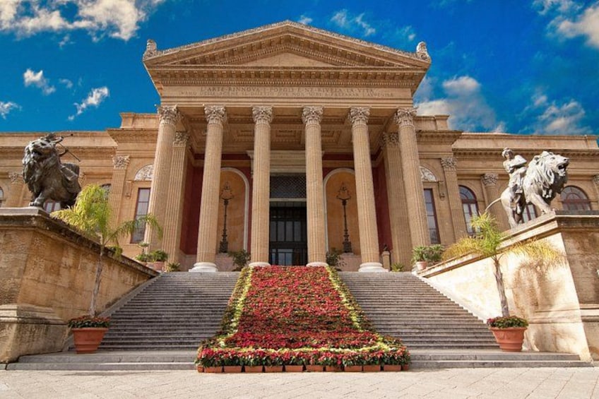 A classical building with columns, a staircase, and statues. 1