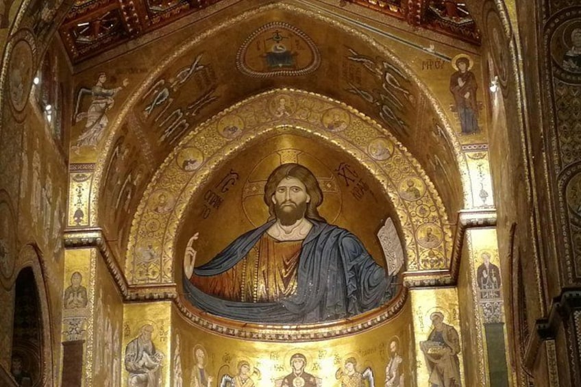 A golden mosaic with a central figure, surrounded by intricate patterns and smaller figures. 3