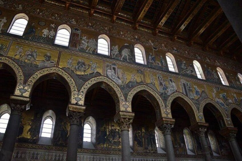 A grand hall with ornate arches and detailed mosaics. 4
