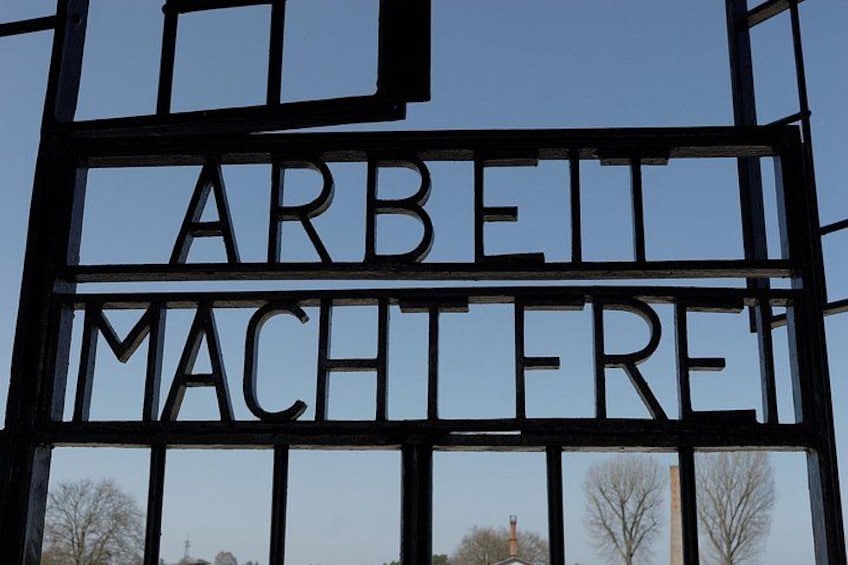 A metal gate with the words 'ARBEIT MACHTEFRE' engraved on it. 5