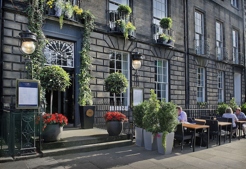 A building with outdoor seating and potted plants. 5
