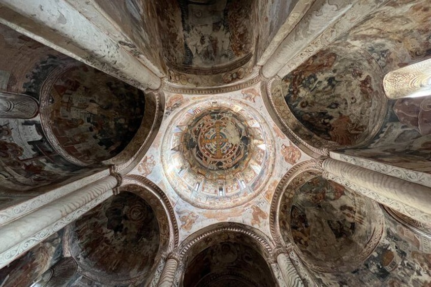 A domed ceiling with intricate frescoes and architectural columns. 3