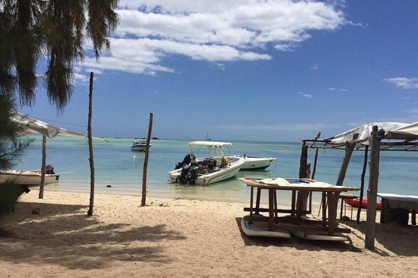 Une plage avec des bateaux, une structure en bois et un ciel dégagé. 2