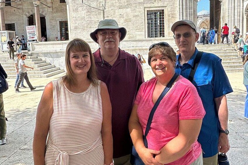 A group of people standing in front of a historic building with columns and steps. 5