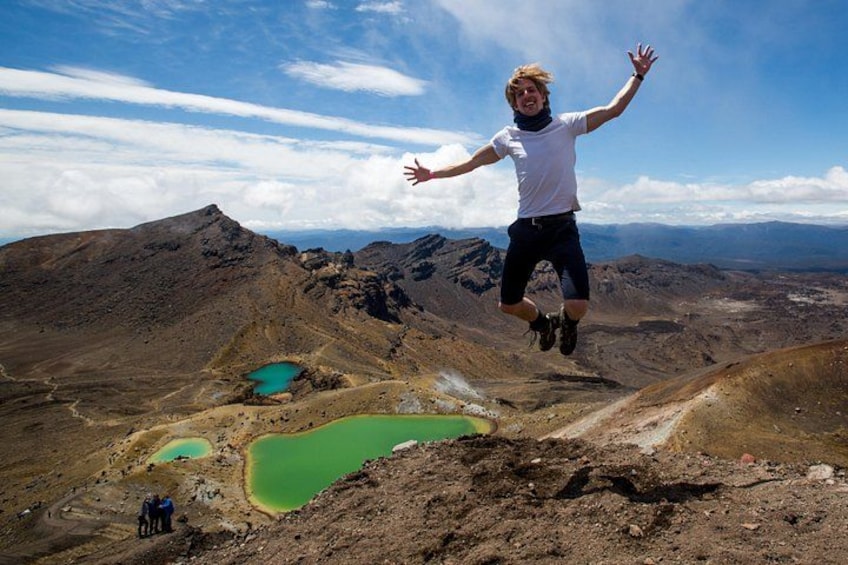 A person jumping in mid-air with a mountainous landscape in the background. 2