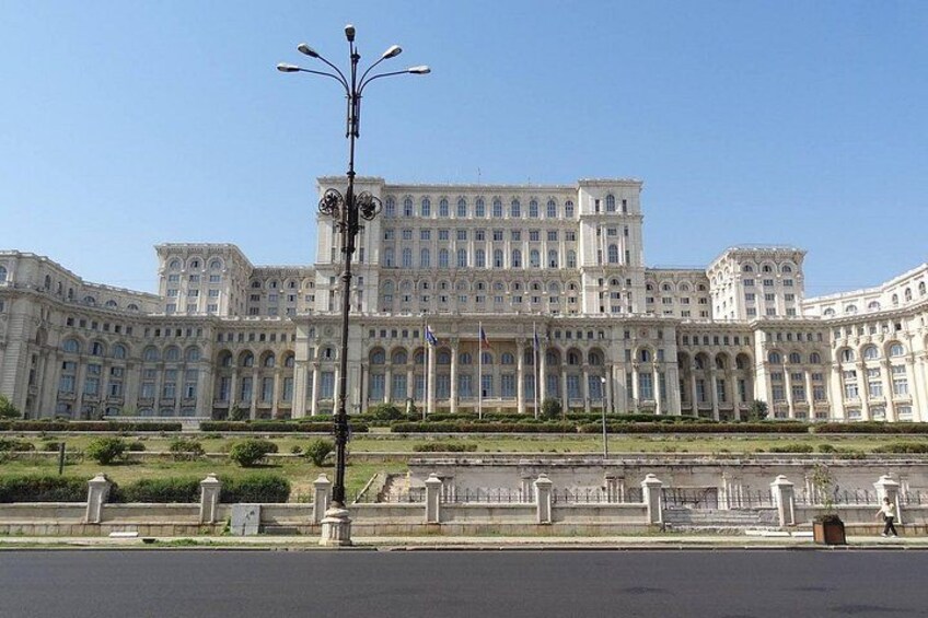A large, ornate building with multiple windows and a symmetrical facade. 5