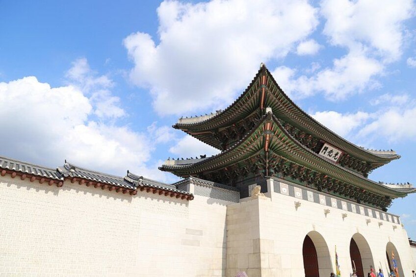 A traditional Korean building with a multi-tiered roof and arched entrances. 5