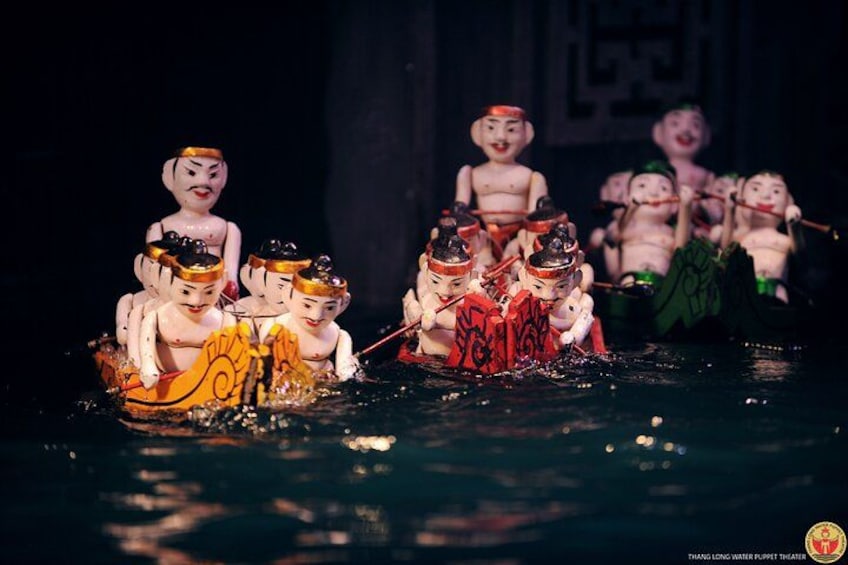 A water puppet theater performance with puppets in boats. 4