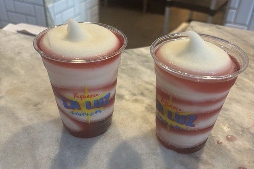Two cups of La Luz frozen yogurt with a red and white swirl pattern. 3