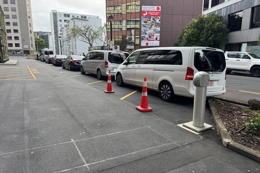 A parking lot with several cars and traffic cones. 2