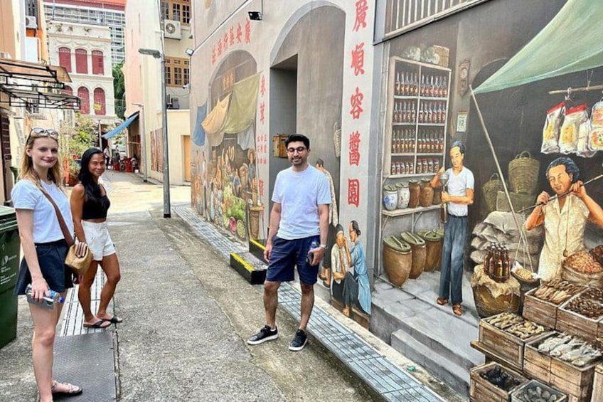 Our back alleys have been given a new lease of life, as our American & English guests marvel at a wall mural depicting everyday life in an old school coffeeshop in Chinatown by artist Yip Yew Chong 3
