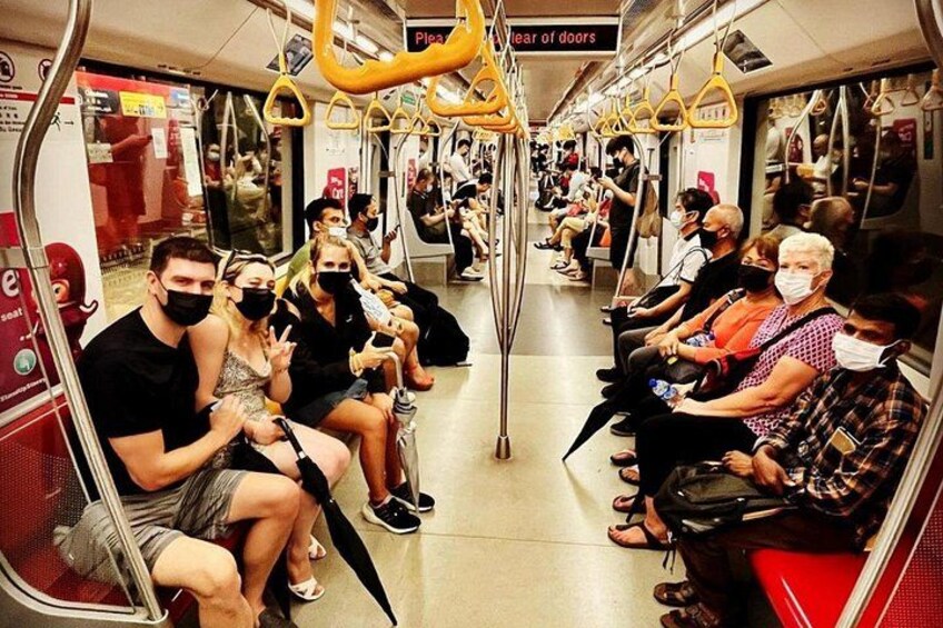 A crowded subway car with passengers seated and standing. 3