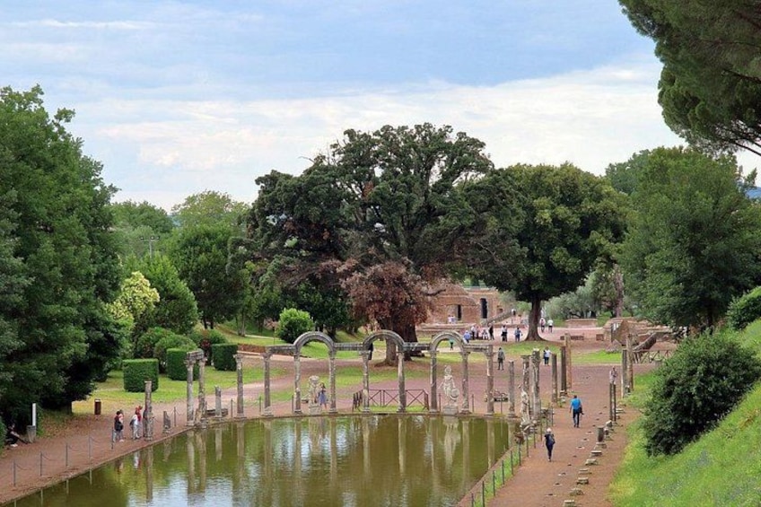 A park with a pond, walking paths, and historical ruins. 4