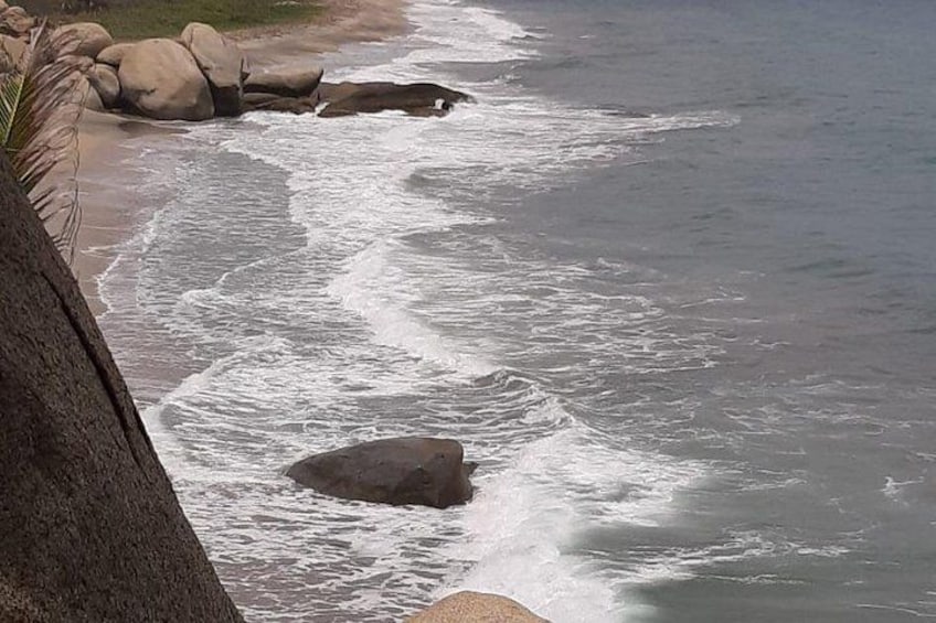 A rocky shoreline with waves crashing against the rocks. 2
