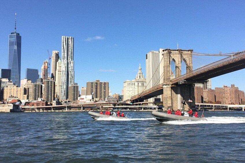 A river with boats, a bridge, and a city skyline with skyscrapers. 5