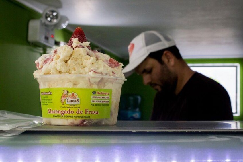 Un récipient de crème glacée avec une étiquette, une personne portant une casquette et un fond vert. 2