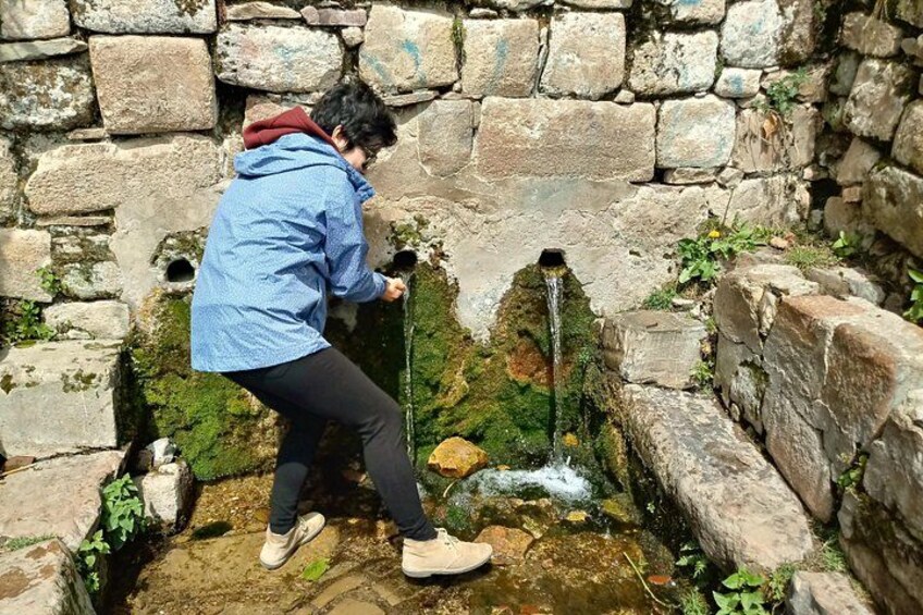 Una persona che esamina una struttura in pietra con un bocchello. 5