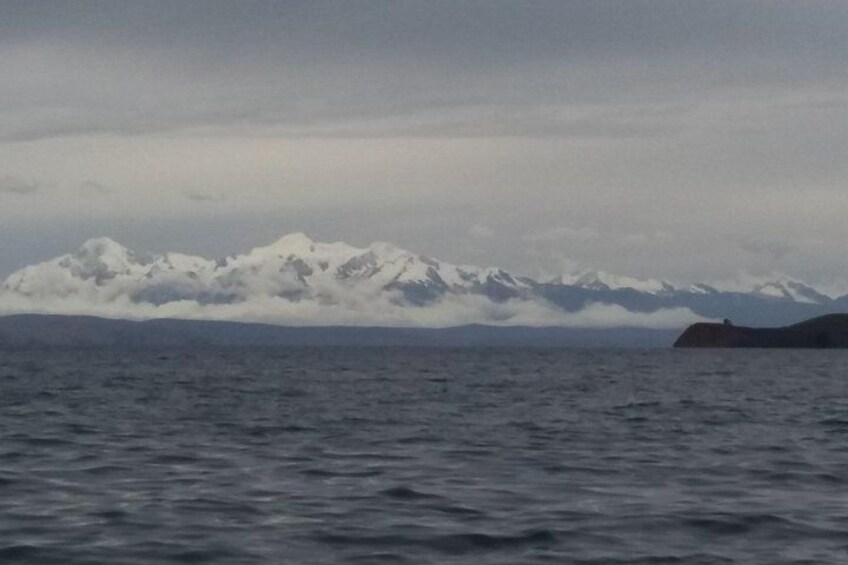Un corpo d'acqua con una catena montuosa in lontananza e una piccola isola. 4