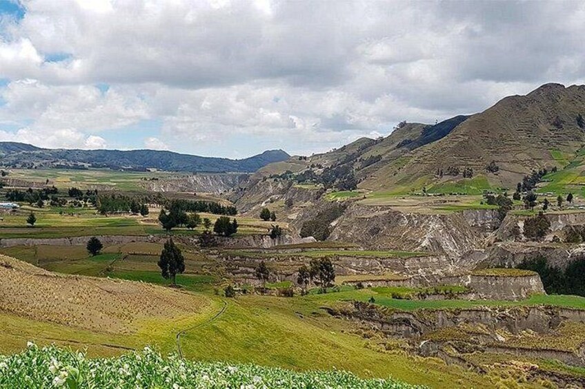 A mountainous landscape with terraced fields and sparse vegetation. 4